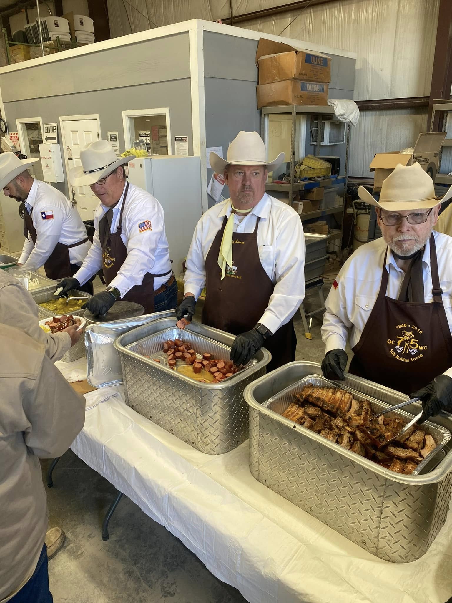Volunteers distributing meals at a gathering