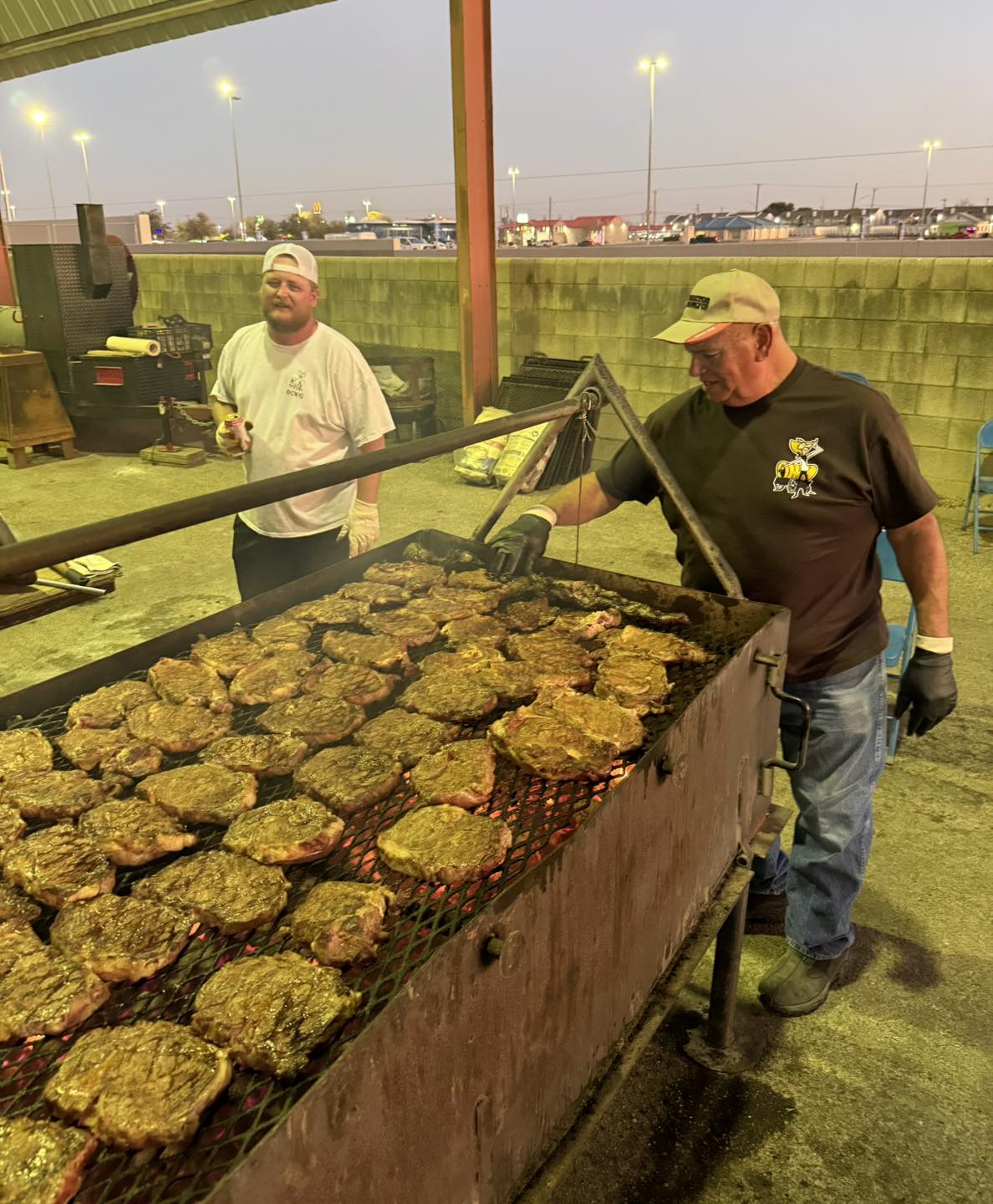 Large barbecue with steaks cooking