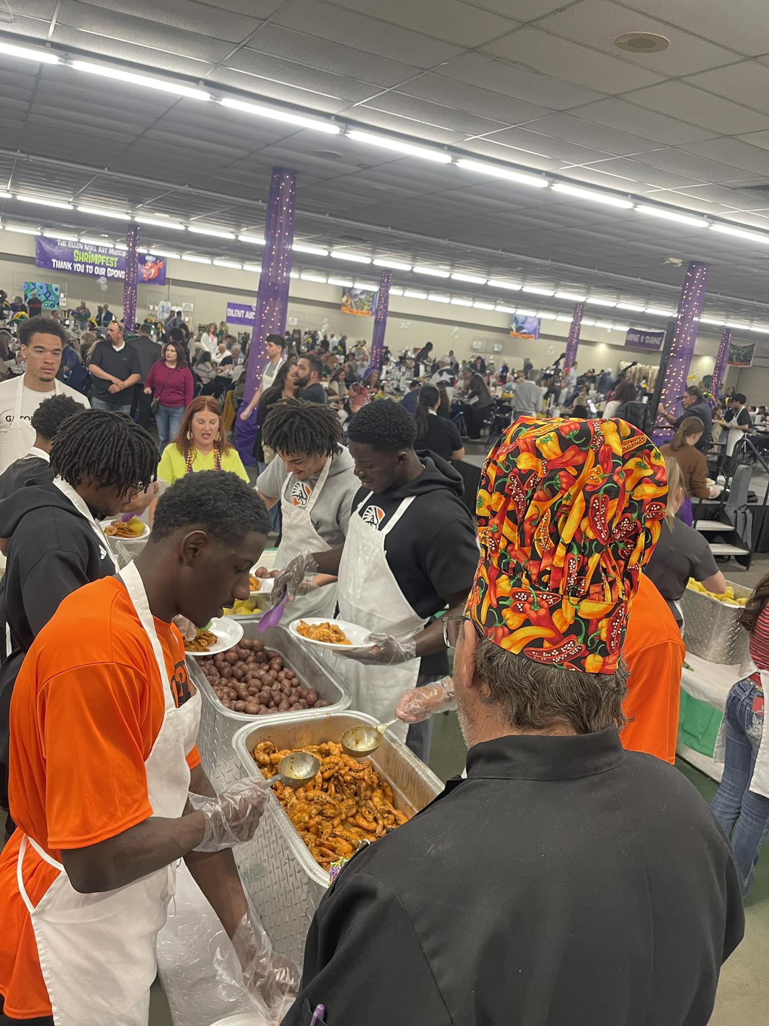 People serving food at community event