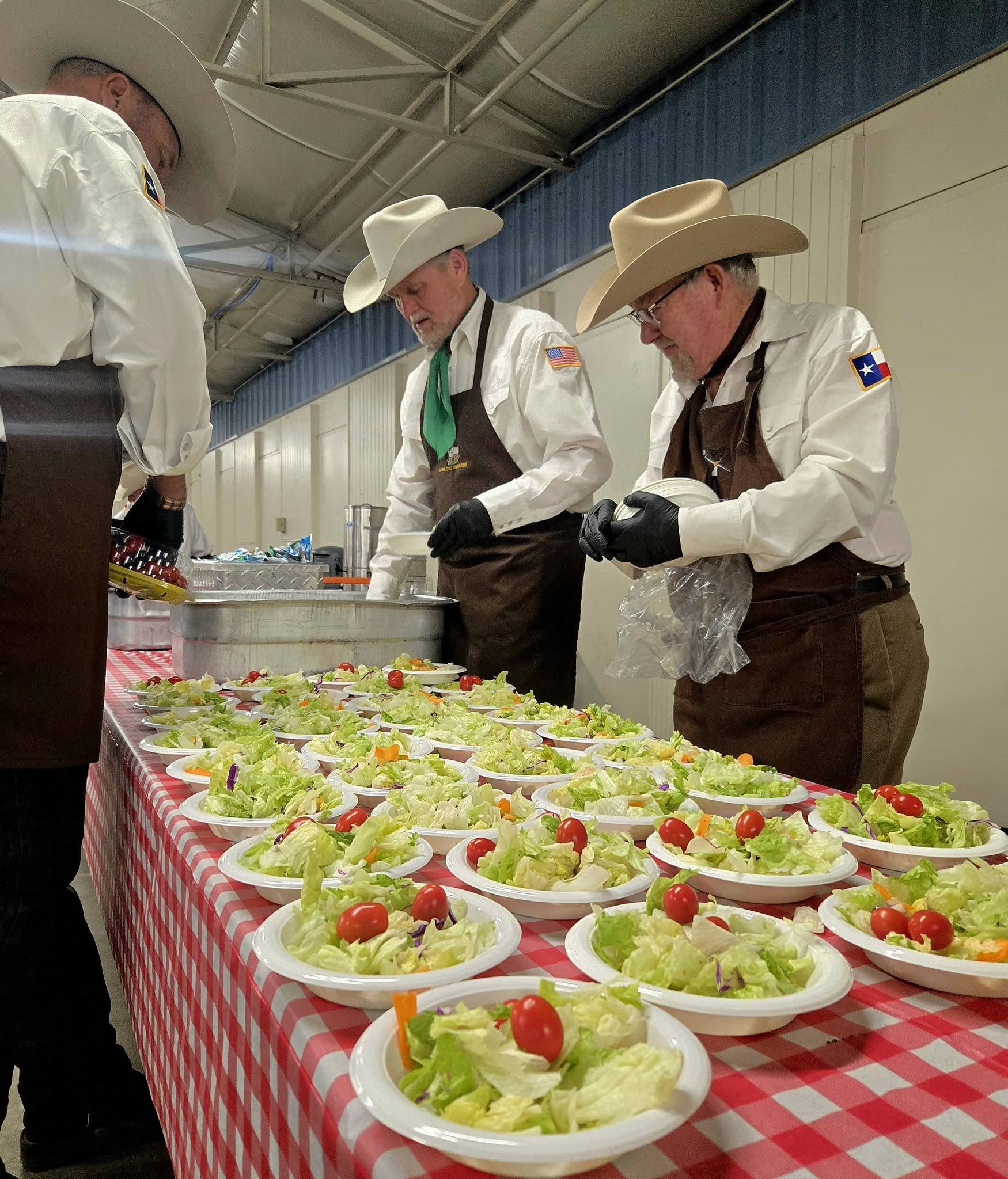 Men in cowboy hats serving salads