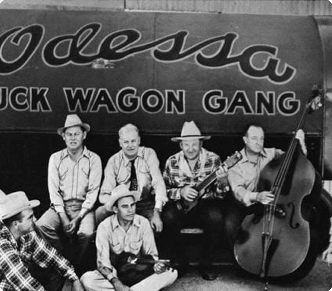 Musicians sitting by vintage truck