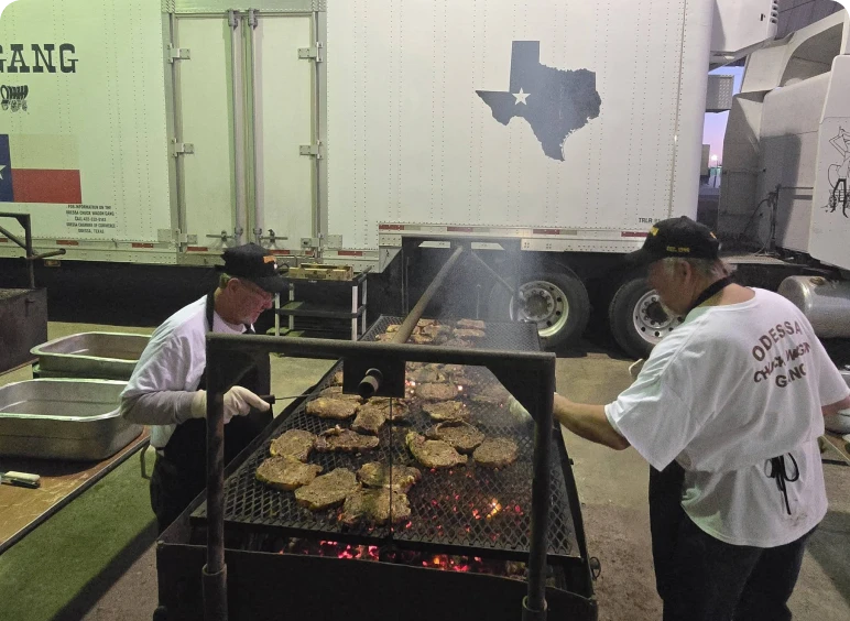 Outdoor barbecue with large steaks grilling