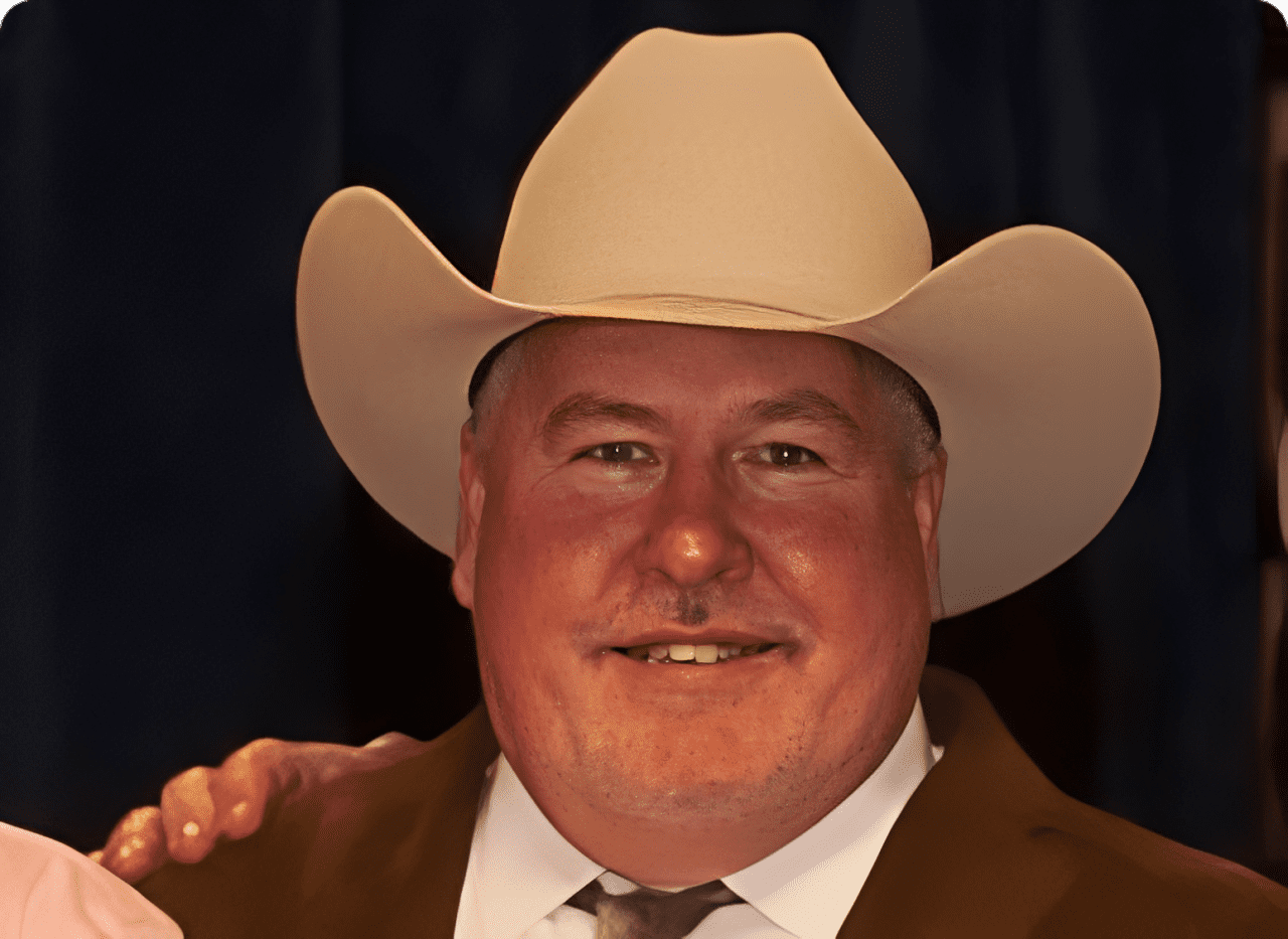 Man wearing cowboy hat smiling