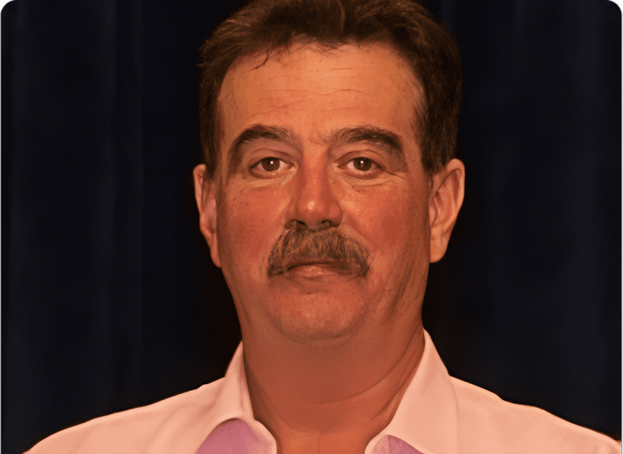 Man in pink shirt with mustache