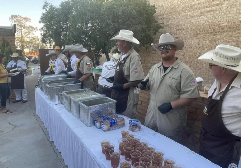 Outdoor event with food servers in hats.